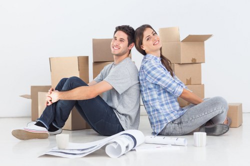 Professional movers loading items into a removals van