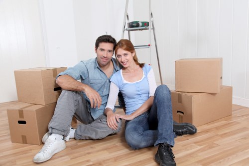Local movers handling furniture in a Brompton apartment building