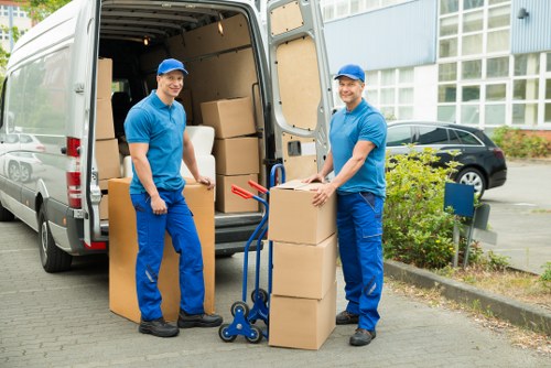 Staff carrying boxes carefully during a Brompton van move