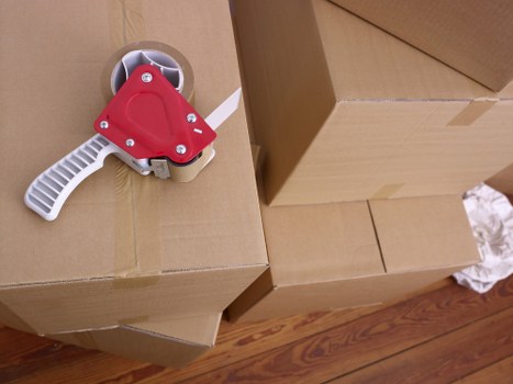 Labeled office boxes and furniture setup for relocation in Brompton