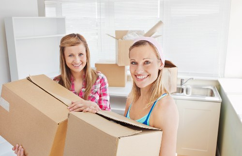Removal team carrying boxes during a local house move in Brompton