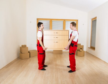 Local movers handling furniture in a Brompton flat with narrow access