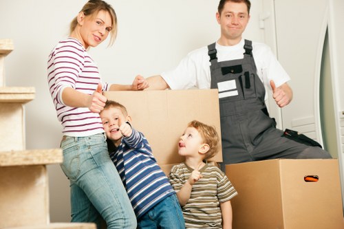 Local moving team handling stairs in a Brompton property